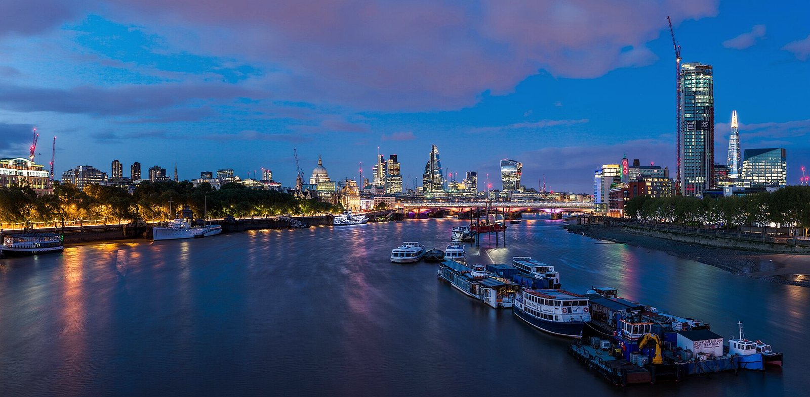 The City of London skyline across the Thames at dusk